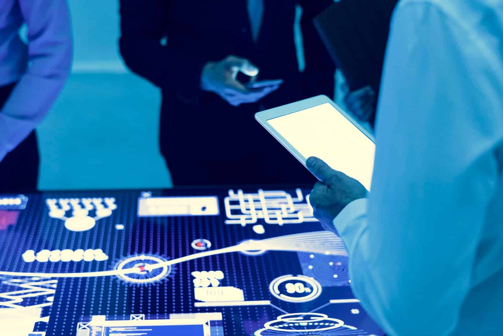 Hands holding using digital tablet in a technology meeting